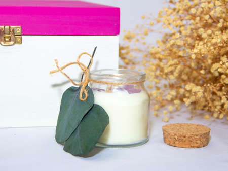 scented candles in glass jar with decorative elementsの写真素材