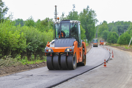 Work on laying of an asphalt paving by means of heavy machineryの写真素材