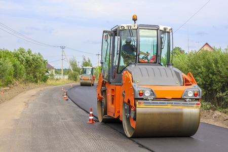 Work on laying of an asphalt paving by means of heavy machineryの写真素材