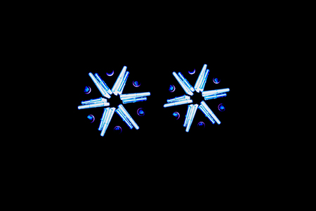 The holographic image of two six-pointed stars on a black backgroundの写真素材