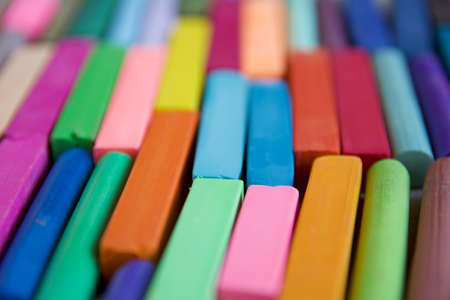 Blurred photo with chopsticks of multicolored art pastels suitable for the background. Symbol of creativity, joy, rich choice.の写真素材