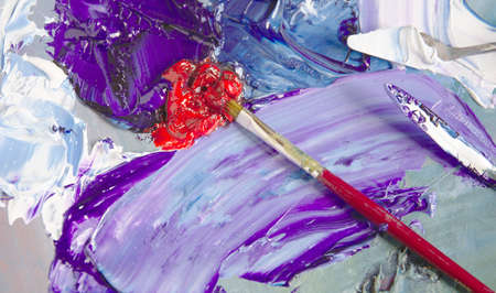 Artist's palette with blue oil paints with a palette knife.の写真素材