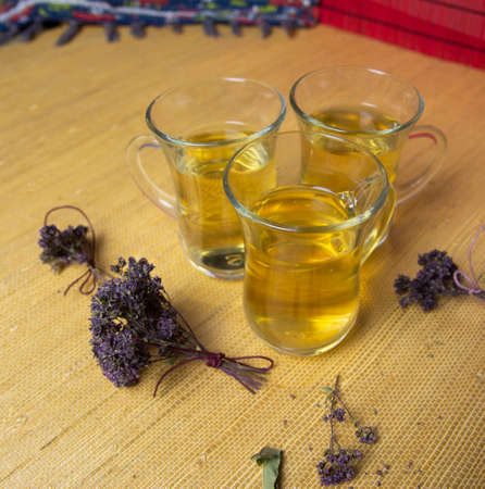 Herbal tea with oregano in glass glasses. A bouquet of dried oregano.の写真素材