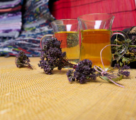 Herbal tea with oregano in glass glasses. A bouquet of dried oregano.の写真素材