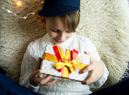 A 10-year-old European boy receives and enjoys a Christmas present.の写真素材
