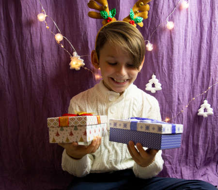 A 10-year-old European boy receives and enjoys a Christmas present.の写真素材