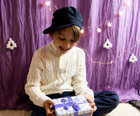A 10-year-old European boy receives and enjoys a Christmas present.の写真素材