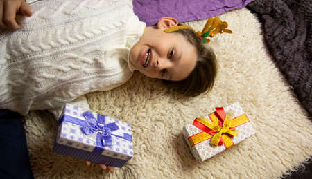 A 10-year-old European boy receives and enjoys a Christmas present.の写真素材