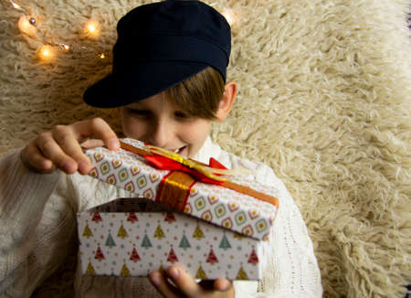 A 10-year-old European boy receives and enjoys a Christmas present.の写真素材