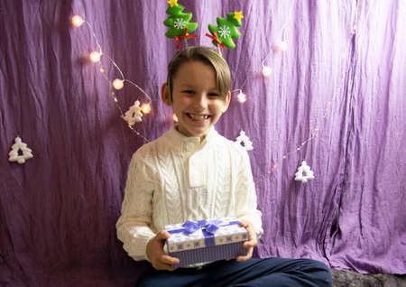 A 10-year-old European boy receives and enjoys a Christmas present.の写真素材