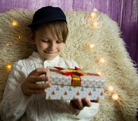 A 10-year-old European boy receives and enjoys a Christmas present.の写真素材