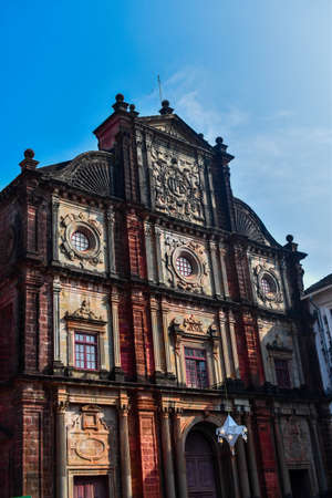 Basilica of bom jesus church in goa taken from lower angle with blue skyの写真素材