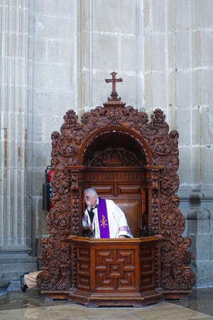The priest and the believer confessing in the church.