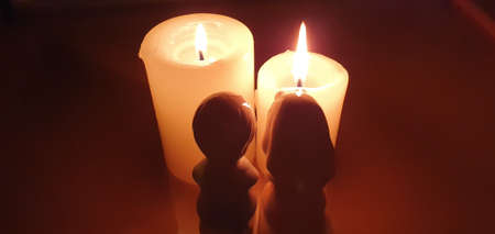 A man who prays eagerly in front of a candle.の写真素材