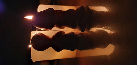 A man who prays eagerly in front of a candle.の写真素材