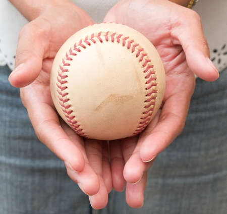 Close-up of Girl's Hand Holding A Well Used Baseballの写真素材