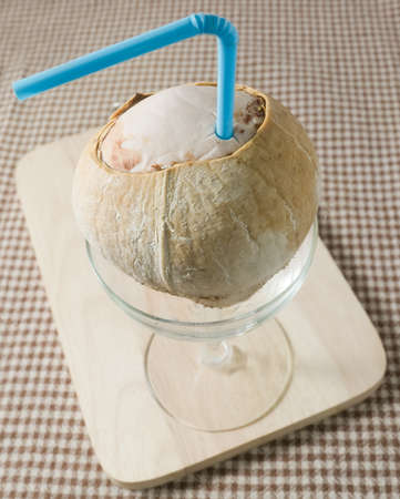 Fresh Fruits, Sweet Coconut with Drinking Straw in A Glass, Grilled Coconut for Sweeter Than Normal.の写真素材