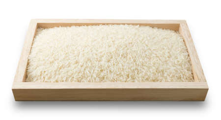 Cuisine and Food, Uncooked White Long Rice, Basmati Rice or Thai Jasmine Rice in A Wooden Tray Isolated on White Background.の写真素材