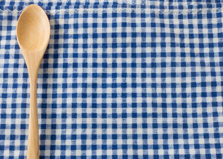 Kitchen Wood Utensil Wooden Spoon on A Blue and White Checked Towel Background.の写真素材