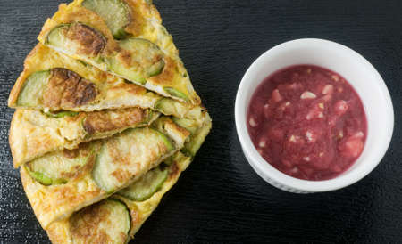 Thai Cuisine and Food, Thai Green Eggplant Omelet Served with Spicy Shrimp Paste Dip on A Black...
