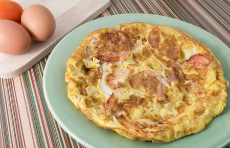 Thai Cuisine and Food, Plate of Thai Style Omelet with Tomatoes and Onion For Quick Breakfast or...