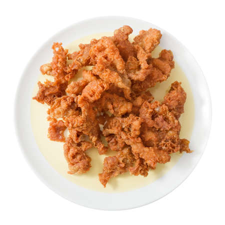 Snack and Dessert, Top View of Thai Traditional Snacks Crispy Fried Chicken Skins Served on A White Plate.の写真素材