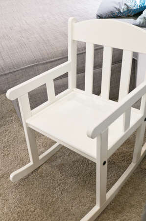 Modern White Rocking Chair on A Gray Carpet.の写真素材