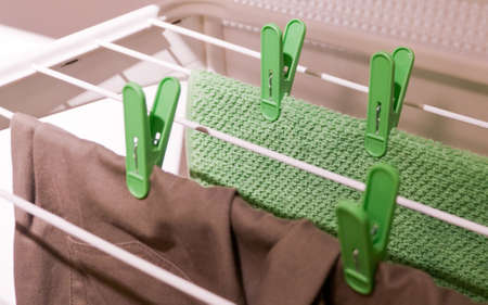 Laundry Clothes Drying on The White Stationary Indoors Clotheshorse.