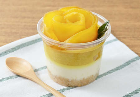 Cup of Mango Cheesecake, A Sweet Dessert Made of Cream Cheese, Biscuits Crust or Cookies Crust and Ripe Mango.の写真素材