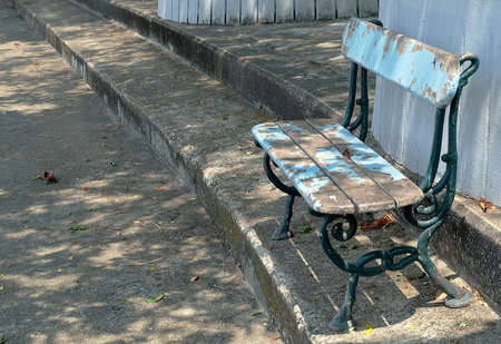Old Rusty Decorative Blue Wooden Park Bench Standing in The Park.の写真素材