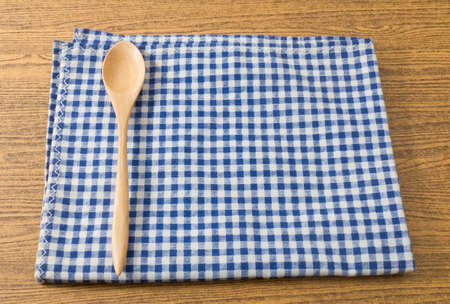 Kitchen Wood Utensil Wooden Spoon on Blue and White Checked Towel.の写真素材