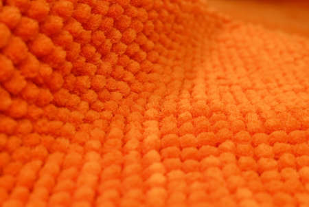 Fabric Texture, Close Up of Orange Plush Pattern Background with Copy Space for Text Decoration. Selective Focus.の写真素材