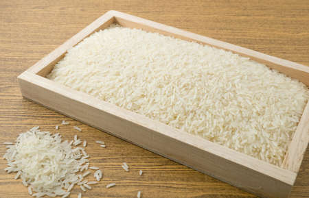 Cuisine and Food, Uncooked White Long Rice, Basmati Rice or Jasmine Rice in A Wooden Tray.の写真素材
