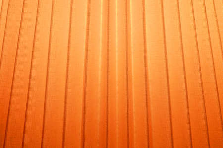 Fabric Texture, Close Up of Orange Pleated Textile Pattern Background with Light.の写真素材