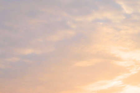 Background Pattern, Fiery Orange Sunrise Sky with Sunlight and Small White Clouds in The Morning with Copy Space for Text Decorated.の写真素材