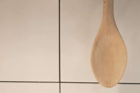 Wooden Spatula or Ladle Hanging on The Wall, Kitchen Utensil for Mixing Ingredients for Cooking or Baking.の写真素材