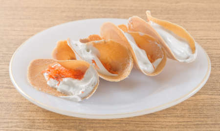 Thai Traditional Snack and Dessert, Crispy Pancake or Crepes Filled with Sweet Coconut Cream and Salted Shredded Coconut.の写真素材