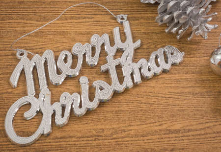 Xmas Ornaments, Merry Christmas Text with Baubles and Pinecones on Wooden Table, Sign for Christmas Celebration.の写真素材
