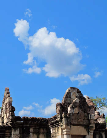 Prasat Sdok Kok Thom The Historical Park in Thailand Against Blue Sky and White Clouds Look Like Elephant, An Ancient Khmer Hindu Temple Dedicated Shiva Made From Red Laterite Brick and Sandstone. の写真素材