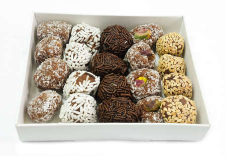 Sweet Food, Assorted Round Chocolate Candy Balls or Chocolate Bonbons in Paper Box Isolated on White...