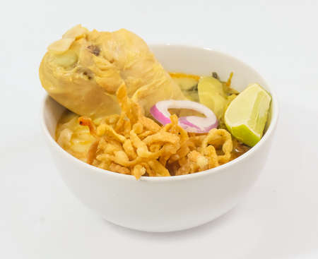 Thai Cuisine and Food, Khao Soi Gai or Traditional Northern Style Curried and Coconut Milk Noodle Soup with Chicken on White Background.の写真素材