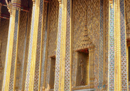 Beautiful Golden Window with Base-Relief Sculpture in Chapel at Wat Phra Kaew Temple and The Grand...