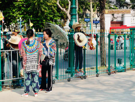 Bangkok, Thailand - February 9, 2019 : Travelers Buying Souvenir Hats From Street Seller at Royal Plaza or Sanam Luang in Front of Wat Phra Kaew and The Grand Palace.のeditorial素材