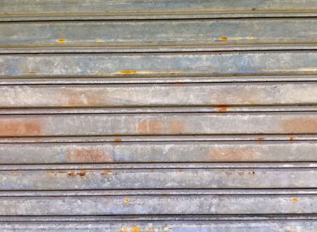 Background Pattern, Horizontal Texture of Rustic Corrugated Metal Sheet or Shutter Door with Copy...