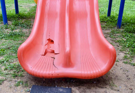 Broken Red Slide in Children Playground, Usually Found in Parks, Schools, Playgrounds and Backyards.の写真素材