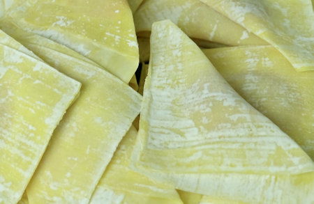 Fresh Wonton Wrappers Filled with Marinated Pork, Ready to be Deep Fried. A Delicious and Popular Snack in Chinese Cuisine.の写真素材
