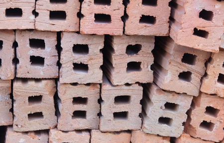 Close Up of Red Brick Blocks Laying on The Ground. Used As Building Brick in The Construction Site. Perfect for Adding A Rustic, Industrial Feel to Your Designs or Presentations.の写真素材