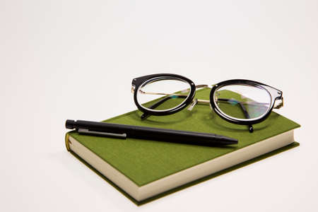 glasses, a book and a penの写真素材