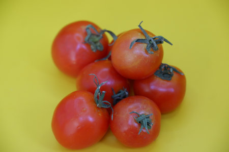 tomatoes on a yellow background, close-up, healthy foodの写真素材