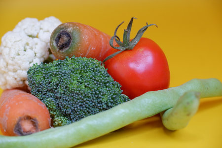 Fresh vegetables on a yellow background. Healthy food. Vegetarianism.の写真素材